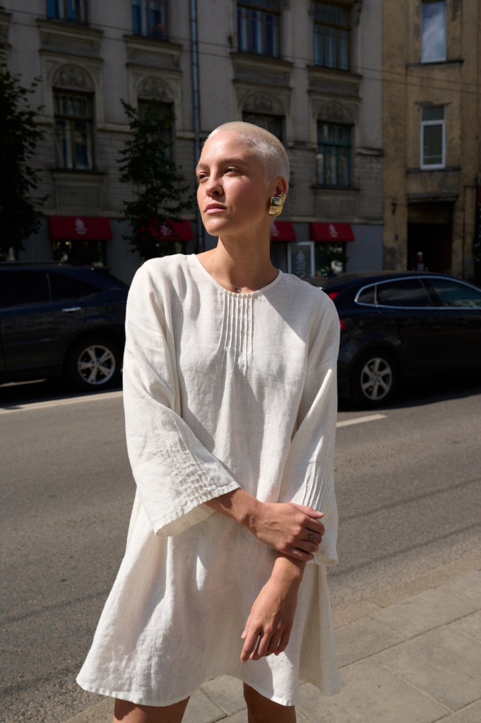 A a model wearing white linen dress in hot weather