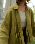 Model is wearing olive green linen jacket
