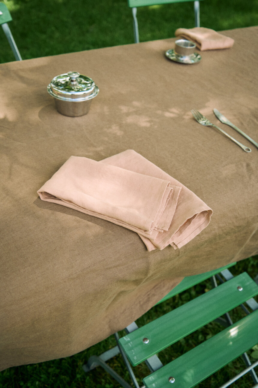 Dusty peach linen napkins arranged on a table.
