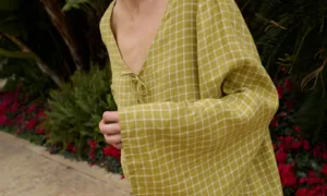 Model wearing a pickle checks linen dress with wide, kimono-style sleeves that flow loosely