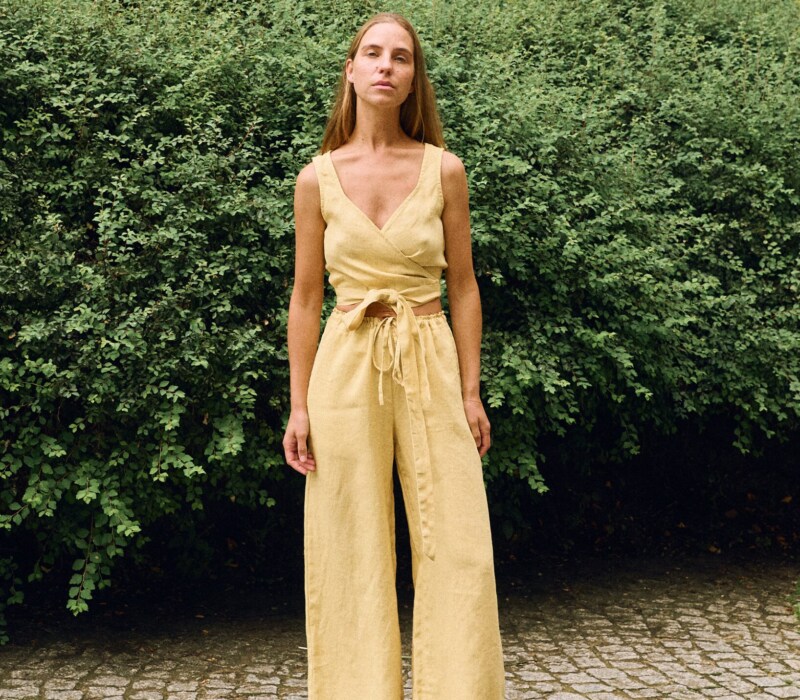 Butter linen two-piece set featuring a wrap crop top and wide-leg trousers, breathable women’s linen outfit