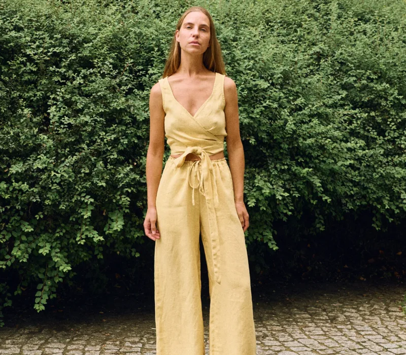 Butter linen two-piece set featuring a wrap crop top and wide-leg trousers, breathable women’s linen outfit