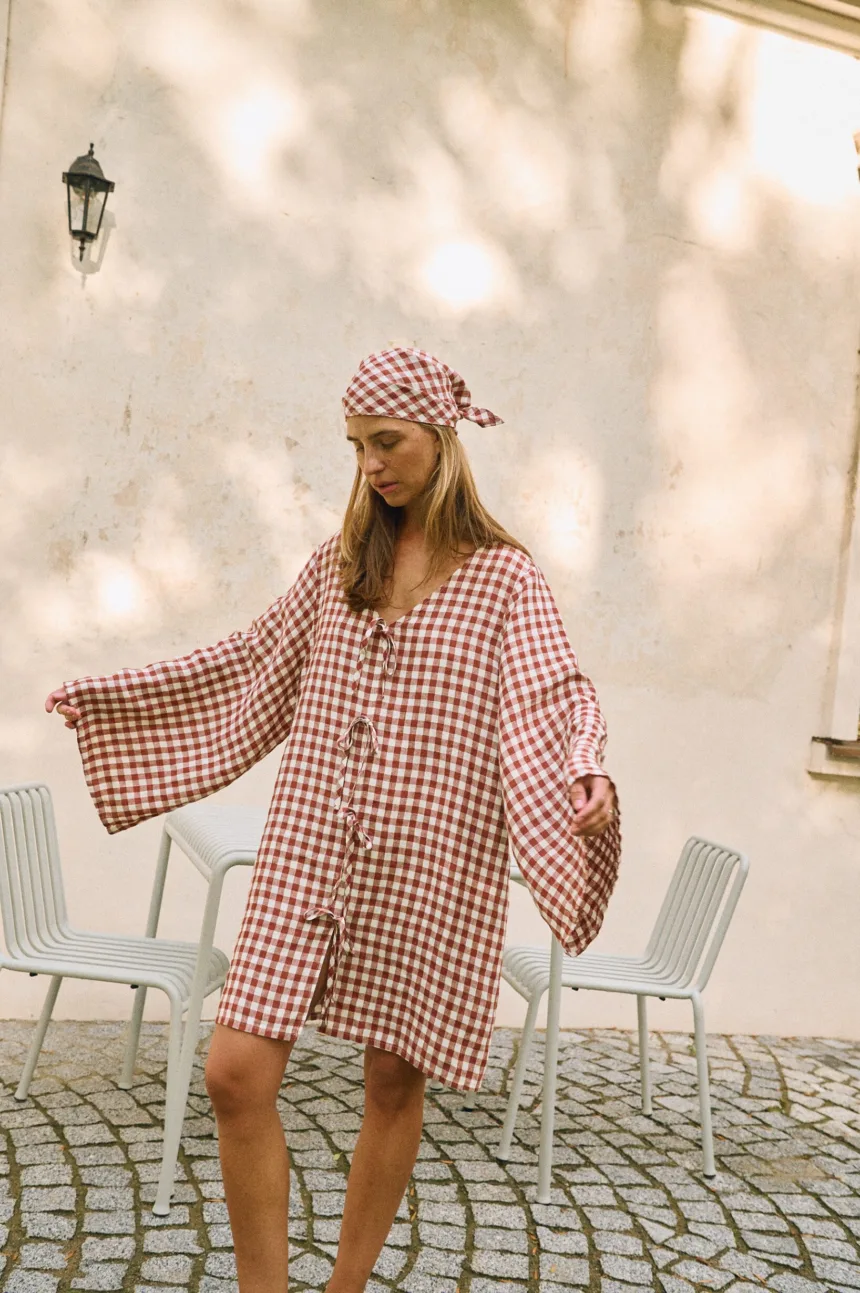 Terracotta and white gingham linen mini dress with decorative front ties and wide bell sleeves