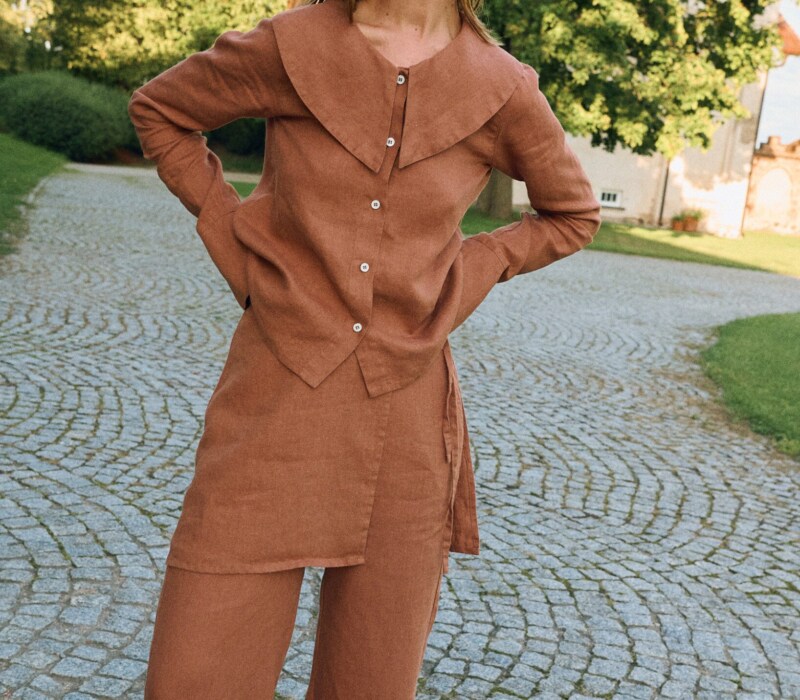Front view of mocha mousse linen blouse with statement collar and relaxed fit, styled with matching linen pants with an overskirt