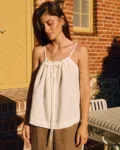 White linen drawstring camisole top paired with wide brown linen trousers