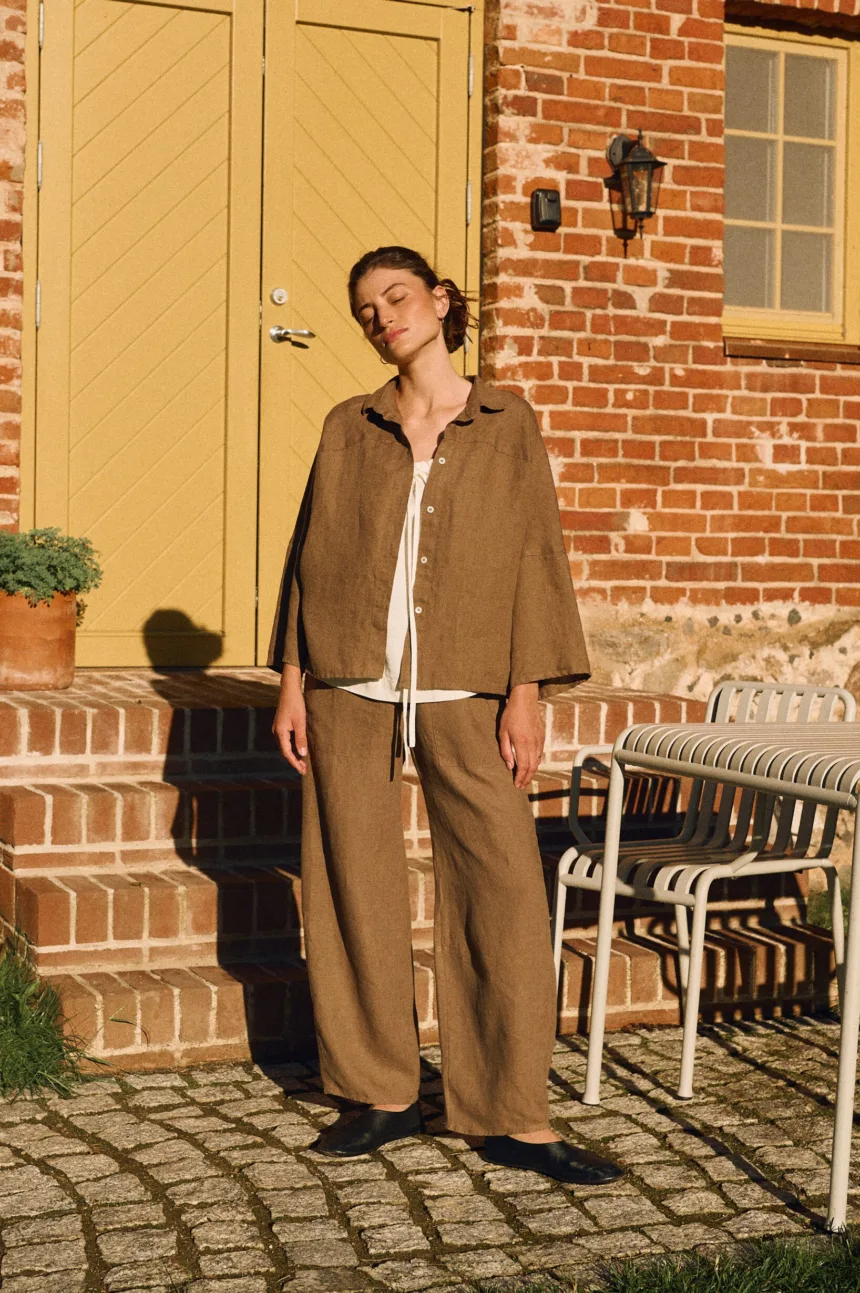 Cacao oversized linen shirt with shell buttons styled with matching high-waisted trousers