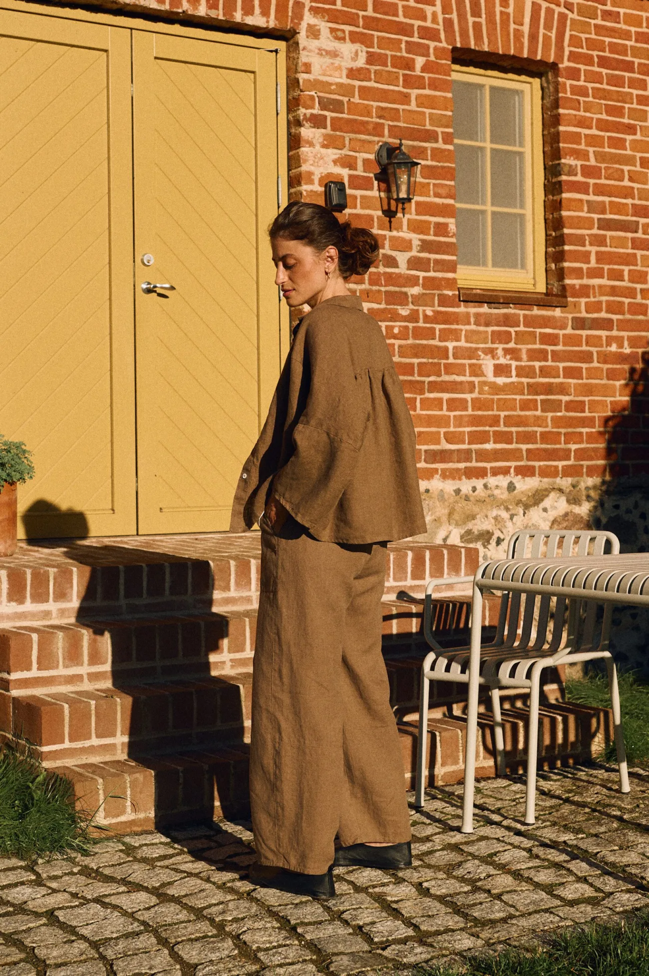 Cacao oversized linen shirt with gathered back detail layered over matching barrel leg trousers