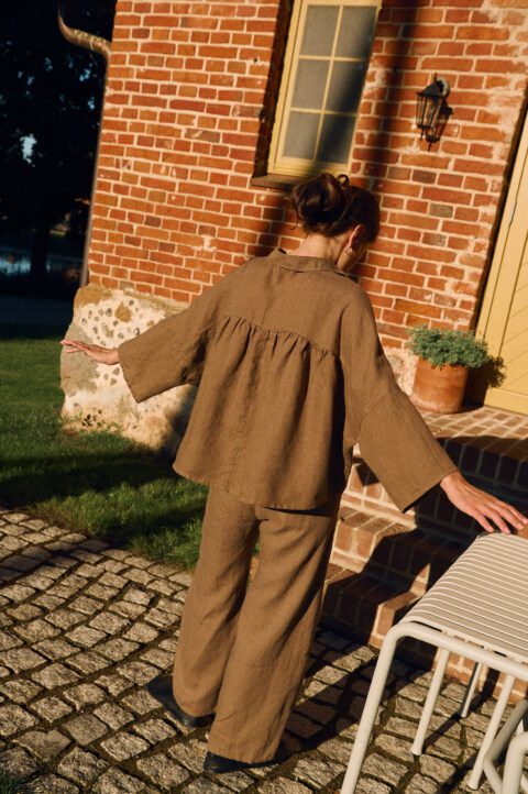 Cacao linen shirt with ruffled gathered back and relaxed oversized fit, back view