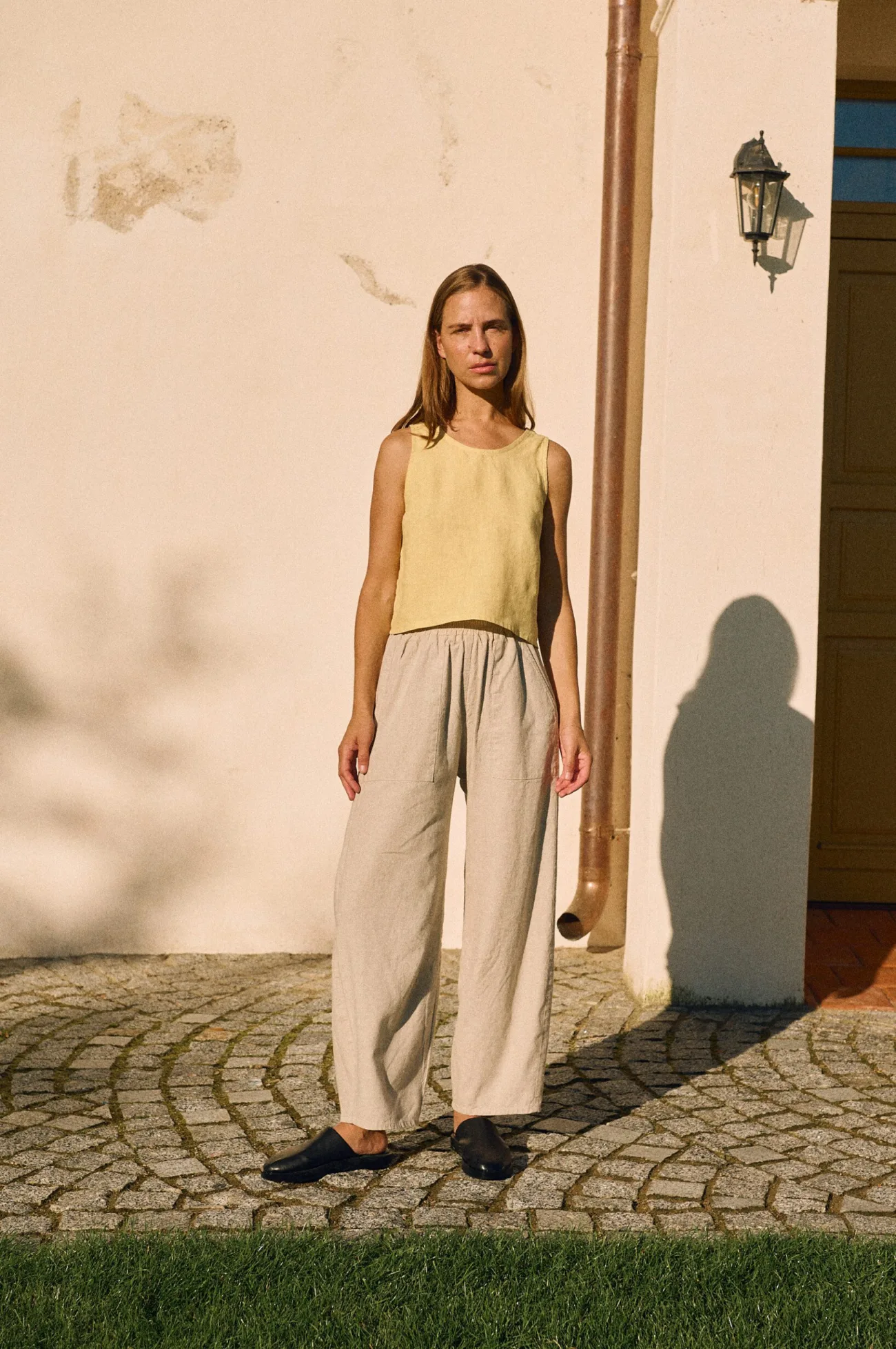 Butter yellow linen cropped tank top paired with natural cotton-linen blend trousers