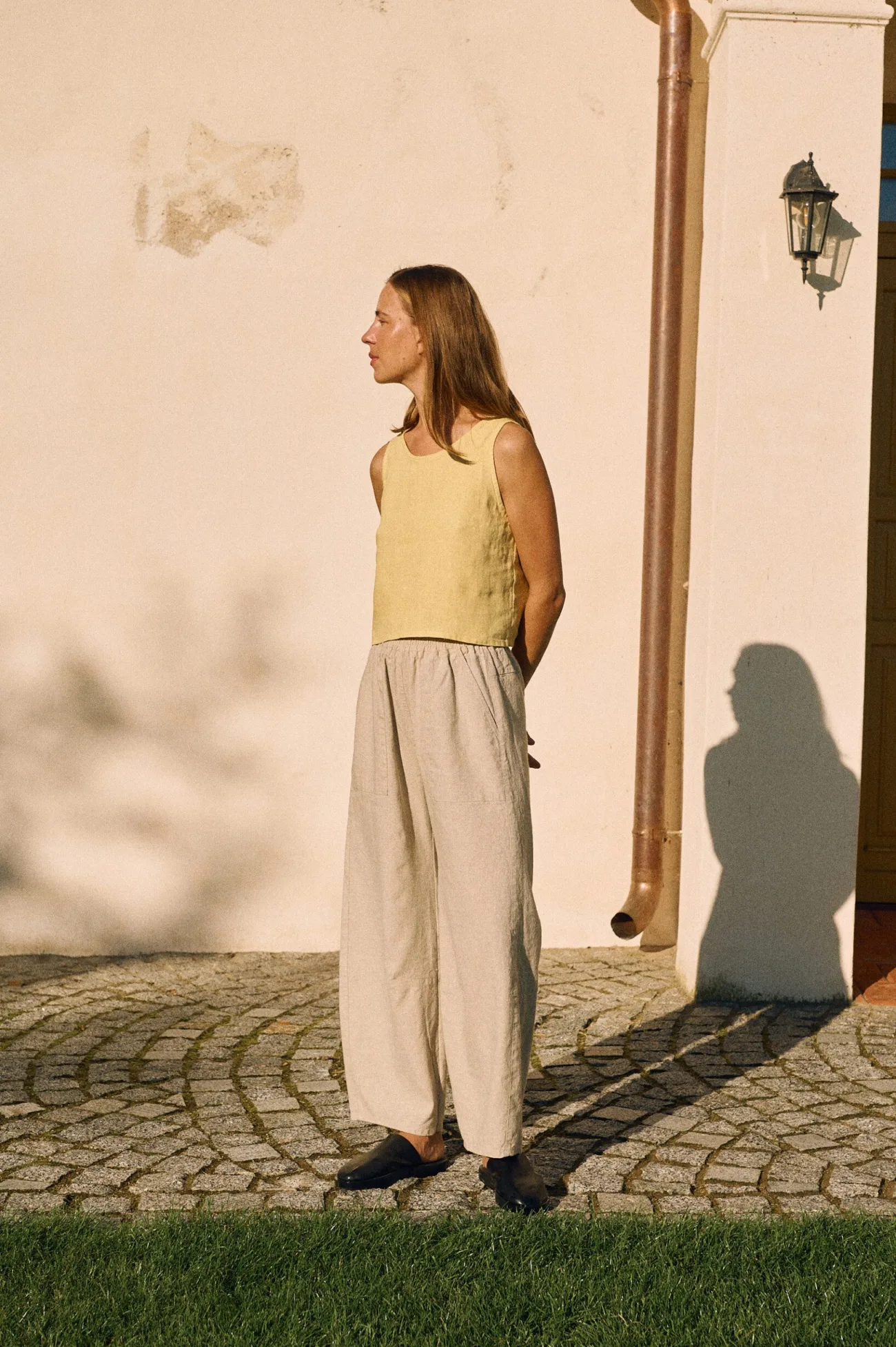 Natural cotton-linen blend high-waisted trousers styled with butter yellow linen tank