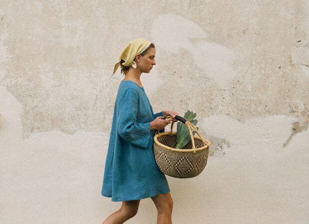 Stellar blue linen mini dress styled with butter yellow headscarf, shown in side profile