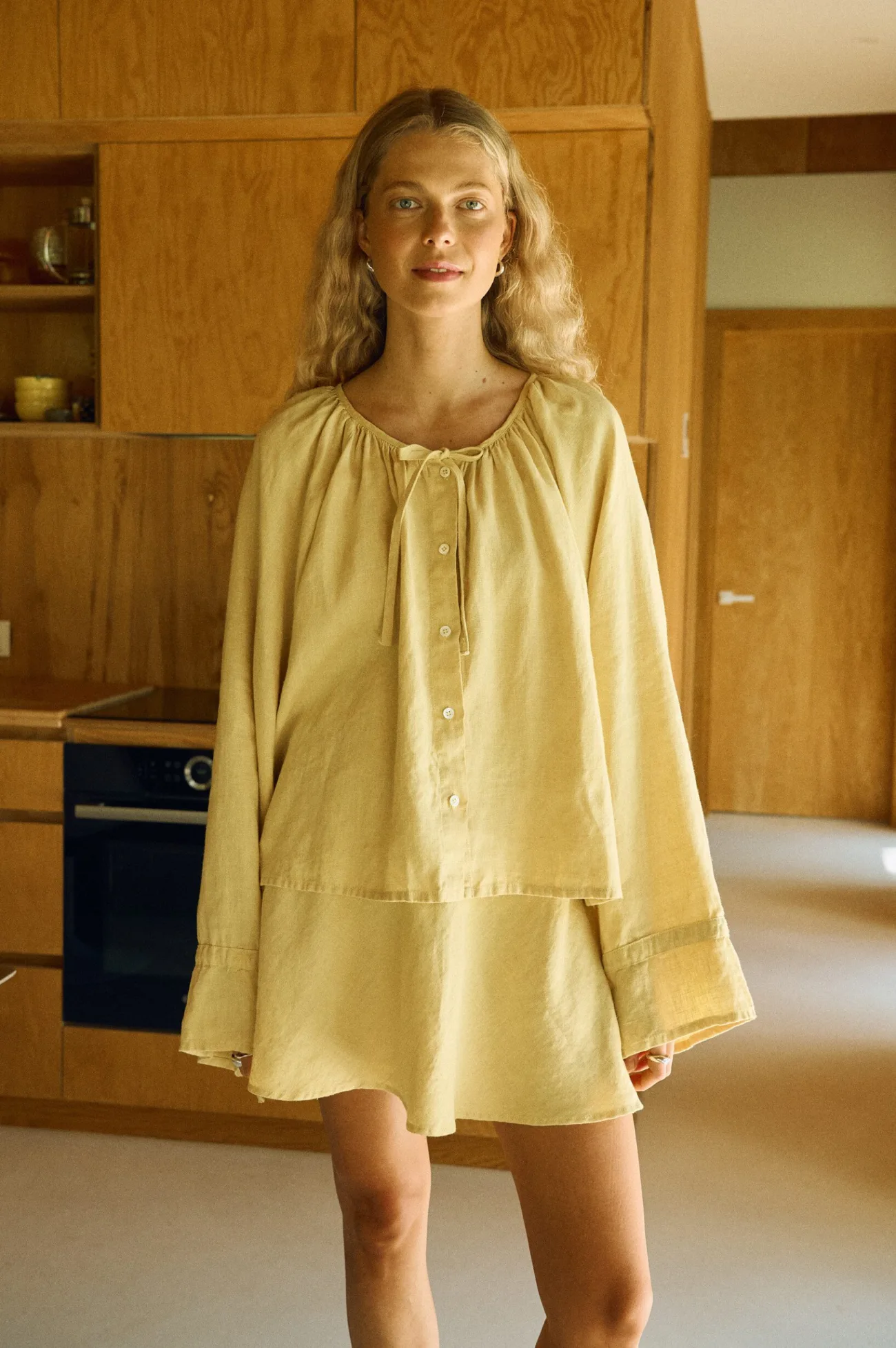 Butter linen two-piece outfit with balloon sleeve blouse and flared mini skirt