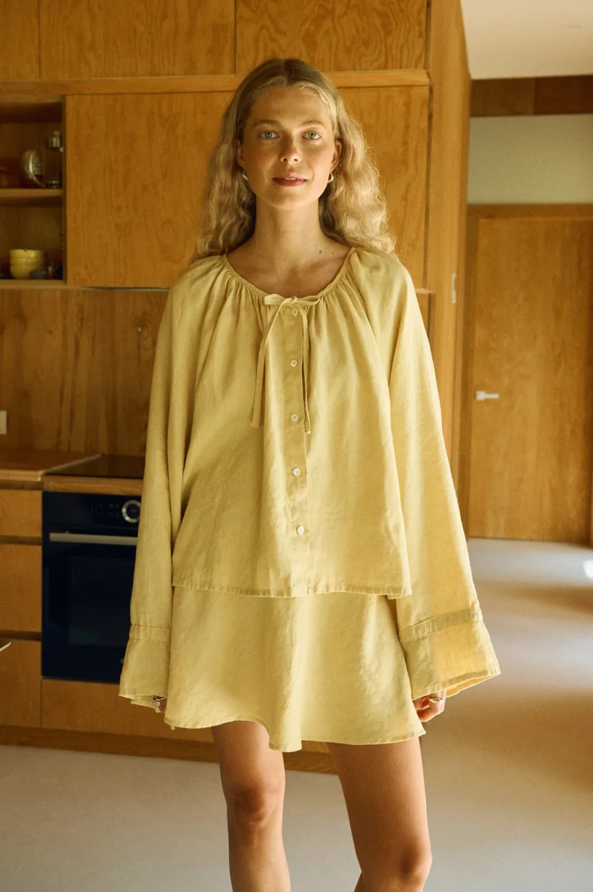 Butter linen two-piece outfit with balloon sleeve blouse and flared mini skirt