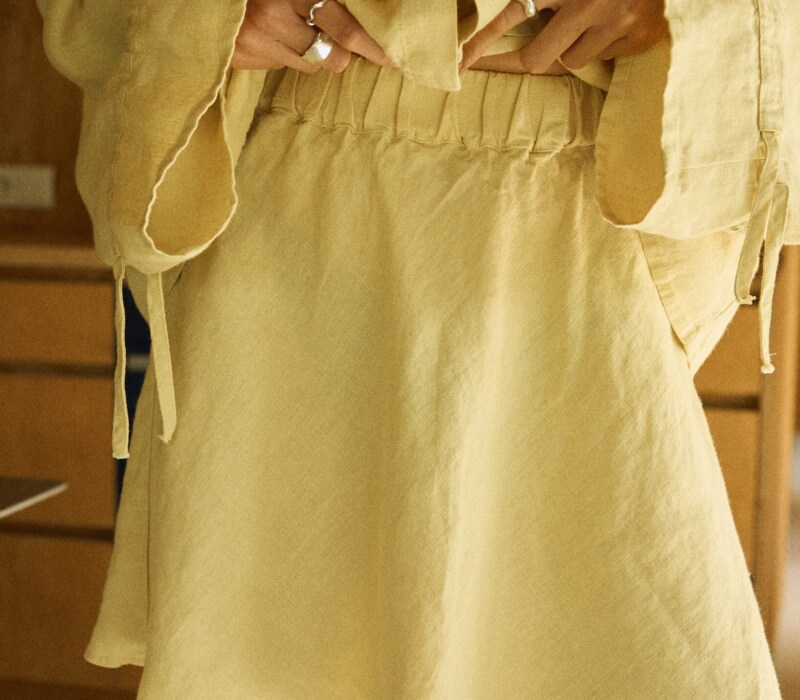 Butter yellow linen mini skirt with flared hem detail and fully elasticated waist
