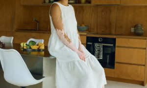 Flowing tiered silhouette of the milky white Amalie dress from a side angle