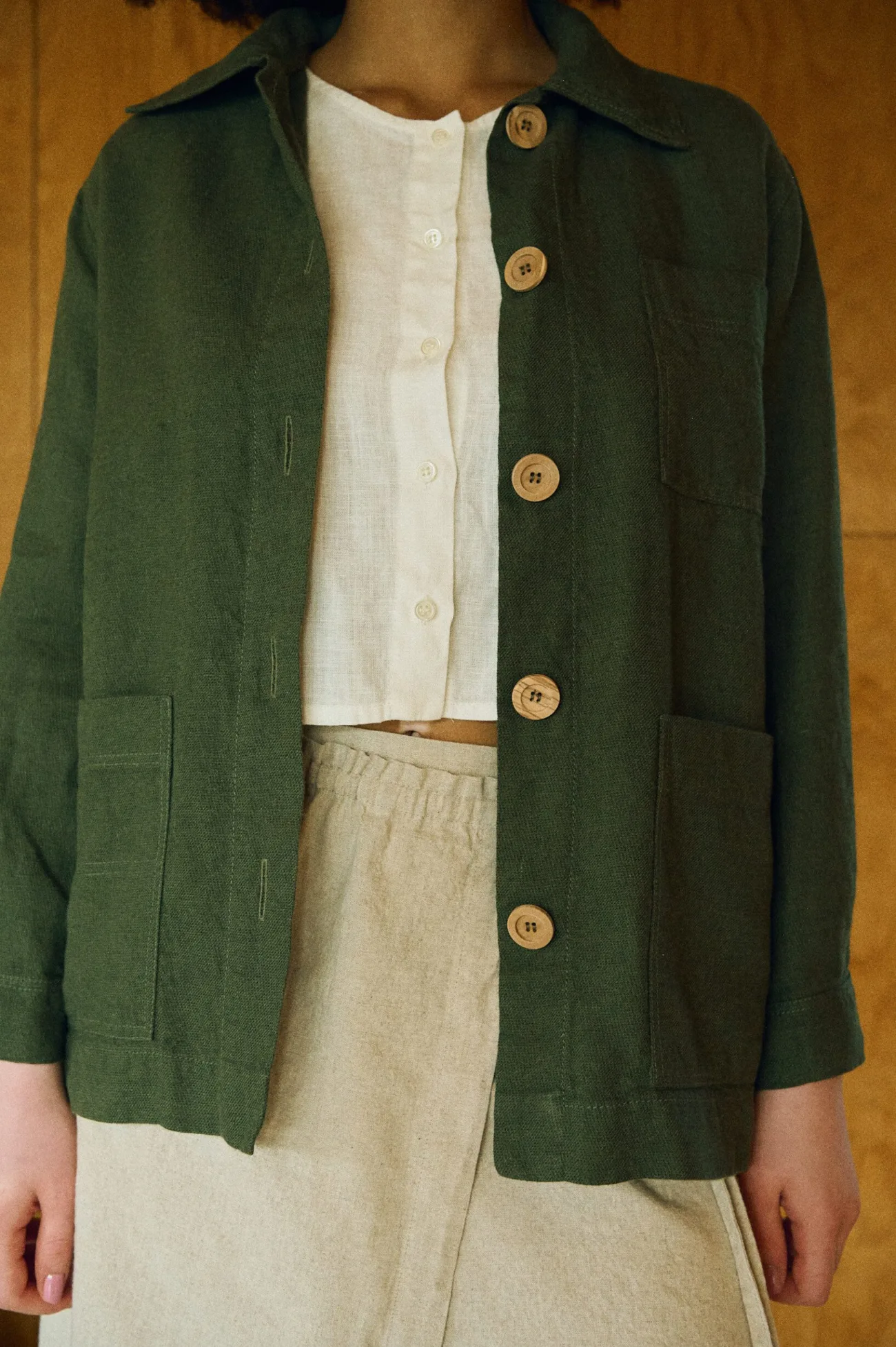 Bill jacket worn open over a linen cropped top and wrap skirt