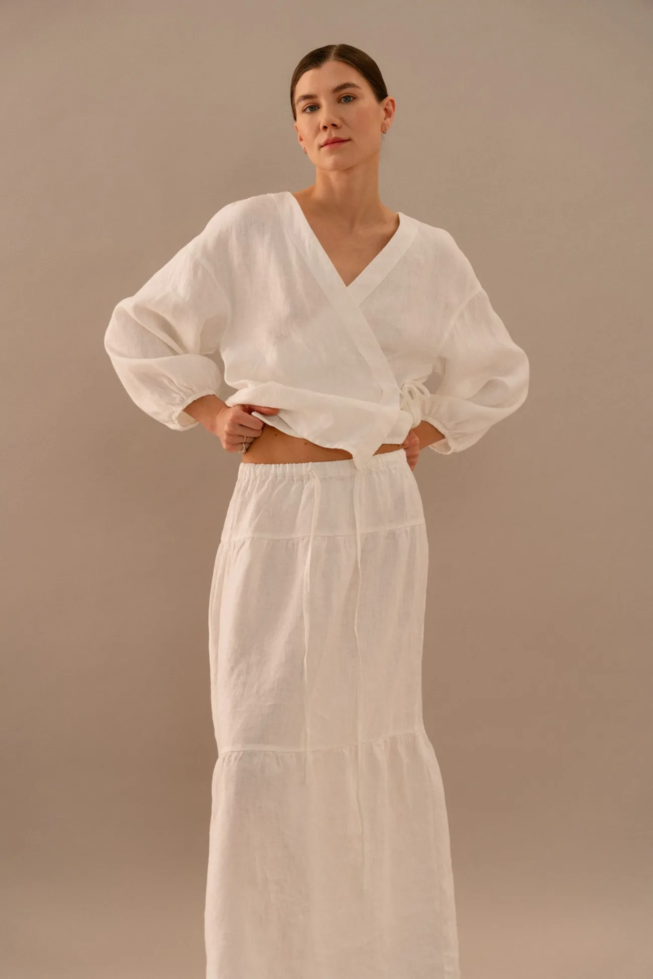 White linen wrap top with V-neckline, tie closure and relaxed long sleeves