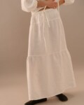White linen maxi skirt with relaxed A-line shape and lightweight texture