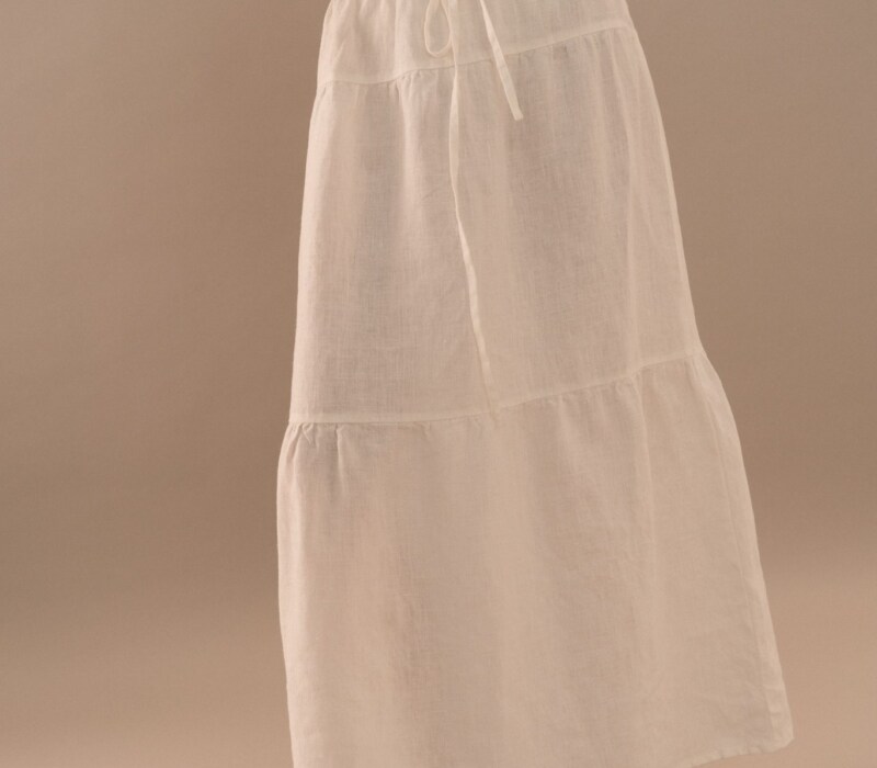 White linen maxi skirt with relaxed A-line shape and lightweight texture