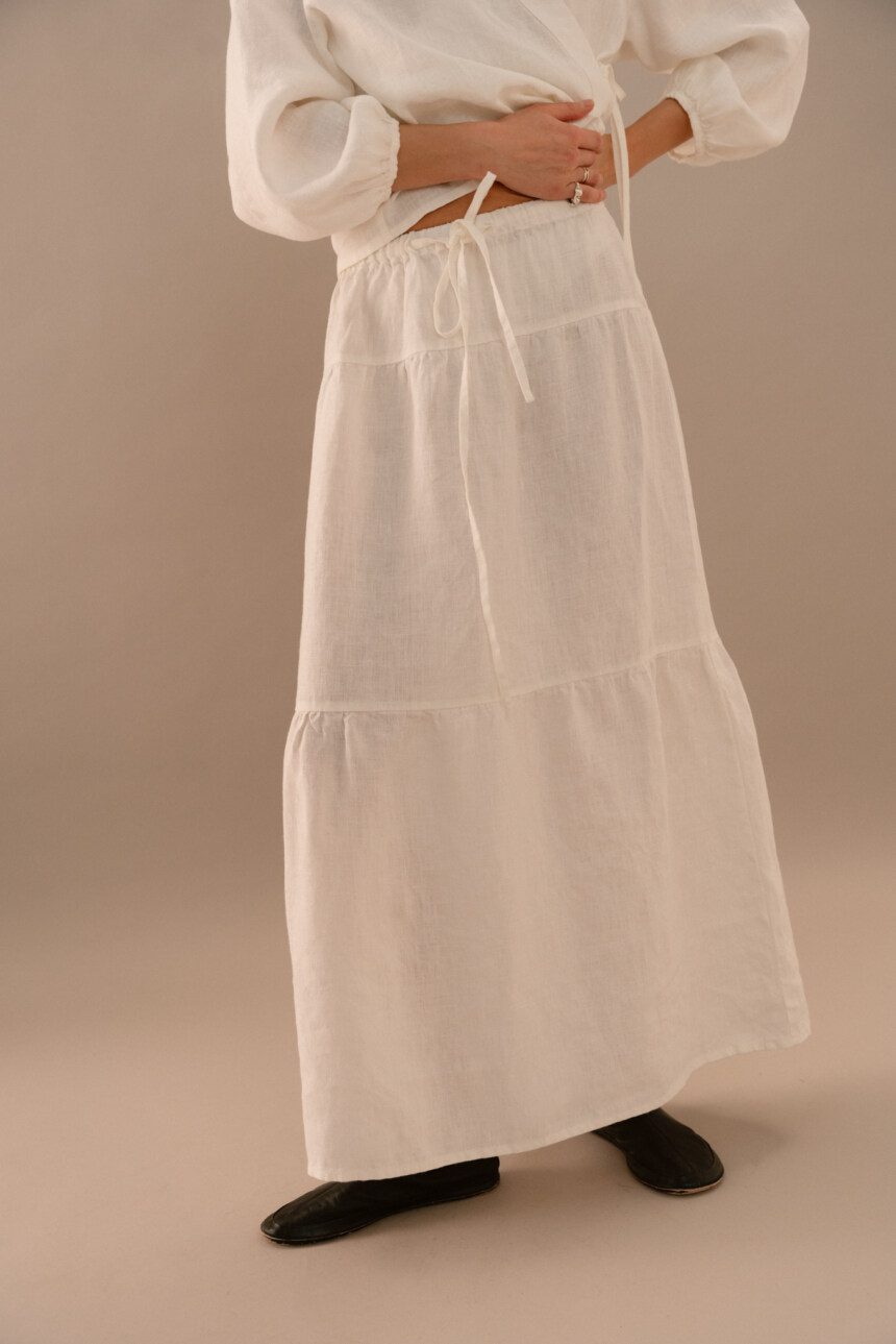 White linen maxi skirt with relaxed A-line shape and lightweight texture