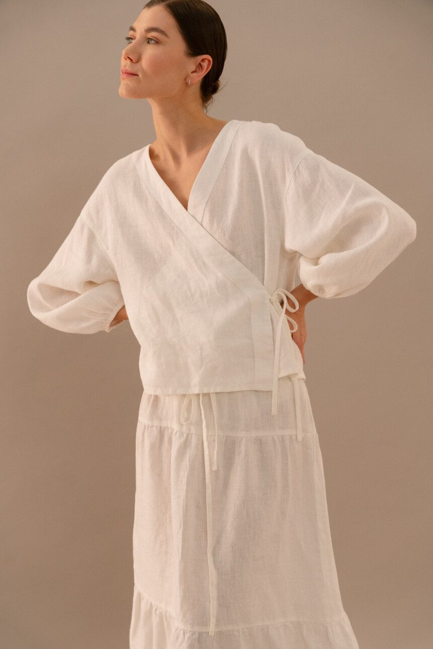 Milky white linen wrap top with side tie and long balloon sleeves paired with tiered maxi skirt