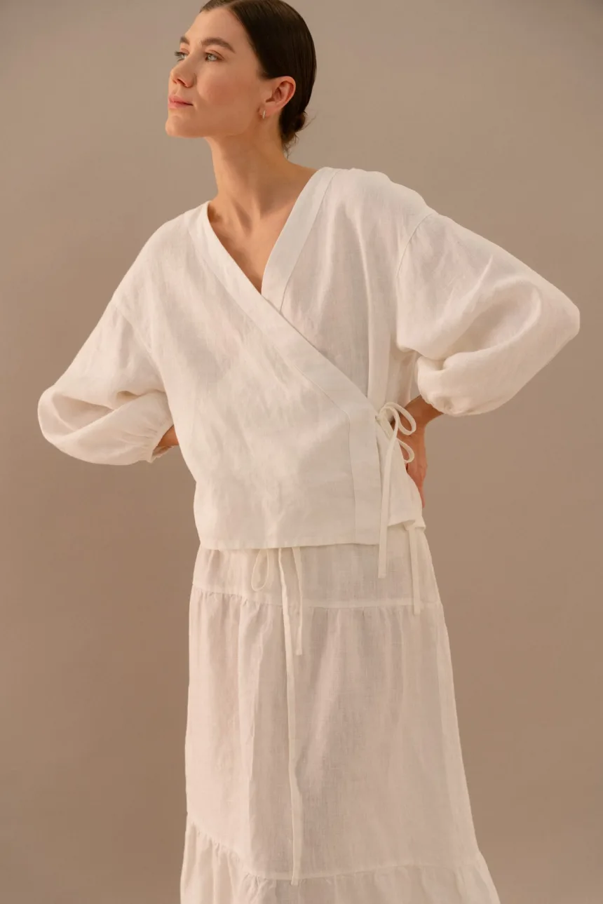 Milky white linen wrap top with side tie and long balloon sleeves paired with tiered maxi skirt