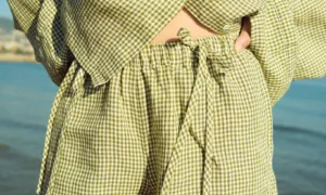 Green mini gingham linen shorts with elasticated waistband and decorative ties, paired with a matching top