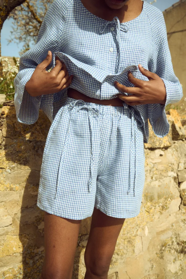 Blue mini gingham linen shorts with relaxed fit and softly gathered elastic waist
