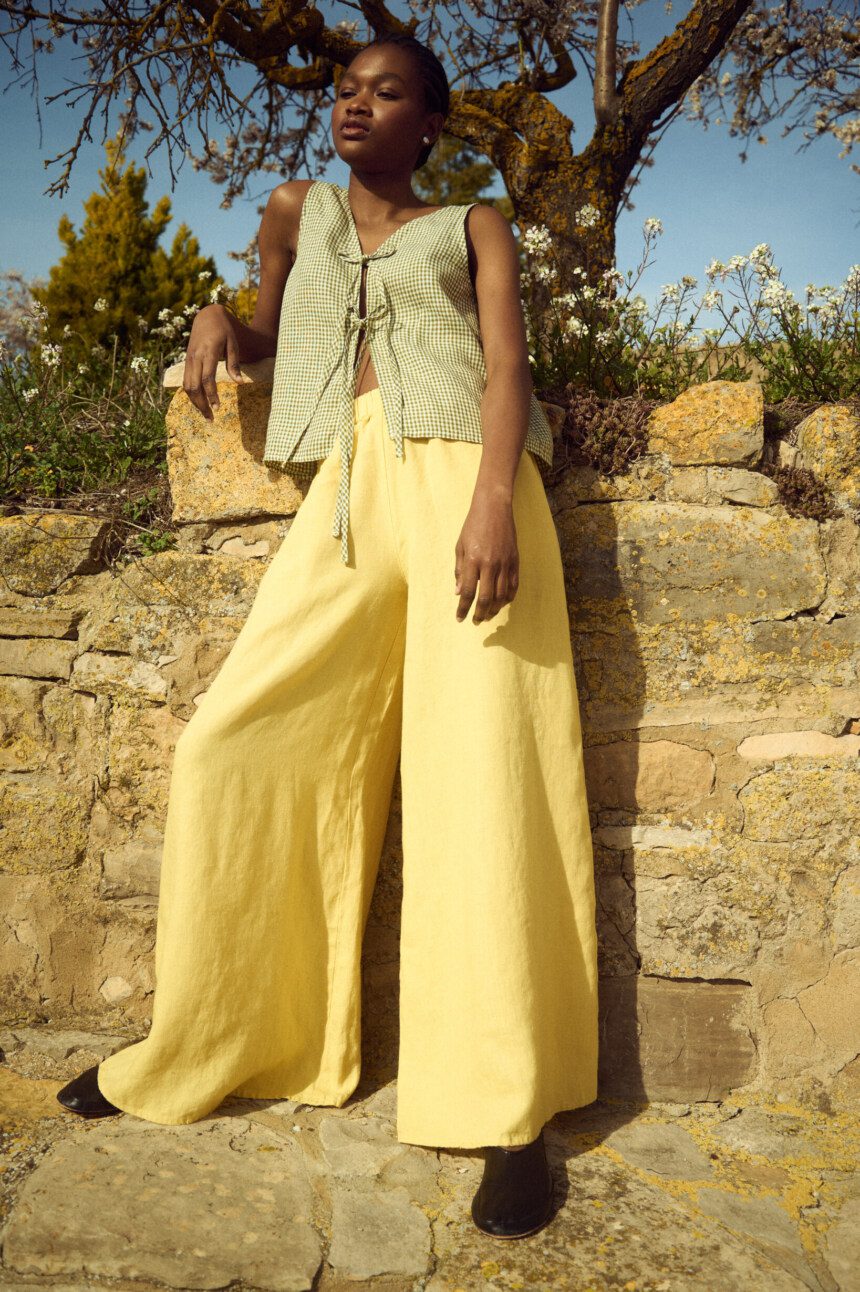 model is wearing butter linen culottes and gingham tie front top