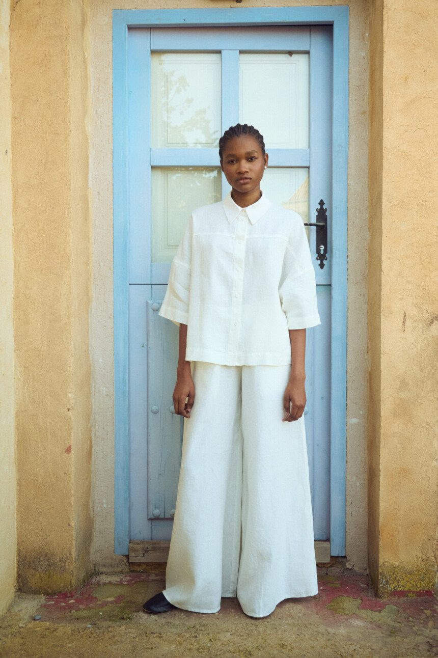 Wide leg white linen culottes worn with matching linen shirt