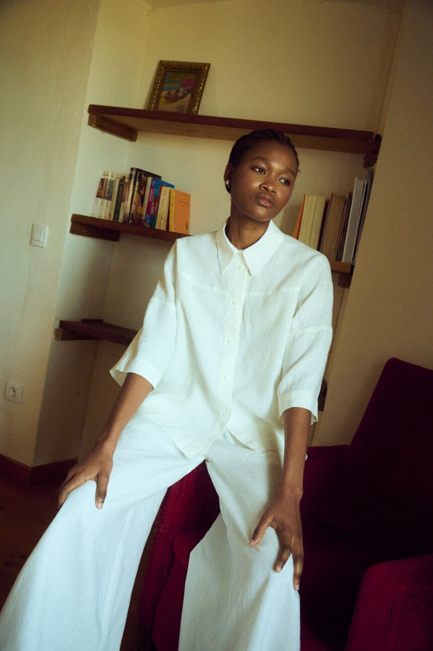model wearing oversized white linen shirt and matching culottes set