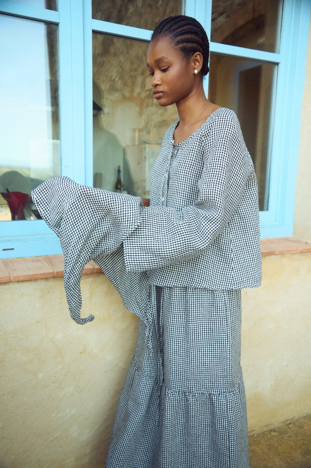 Black gingham linen top with easy silhouette and soft sleeves, worn with a matching long skirt