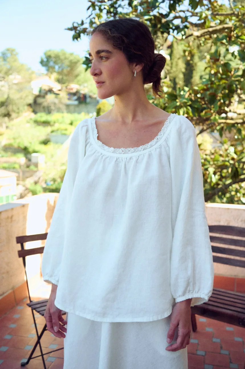 woman is wearing oversized linen tunic in white linen