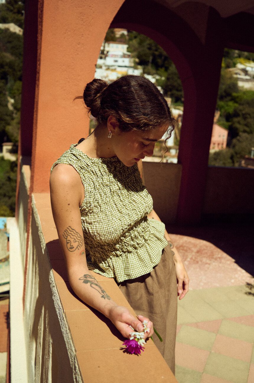Smocked gingham top with fitted bodice and peplum hem