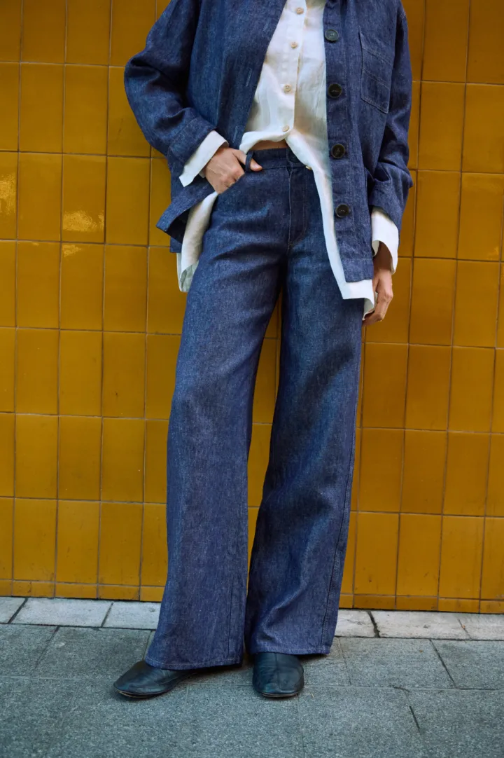 Blue denim linen jeans with wide legs and front pockets, styled with a matching linen jacket and white linen shirt