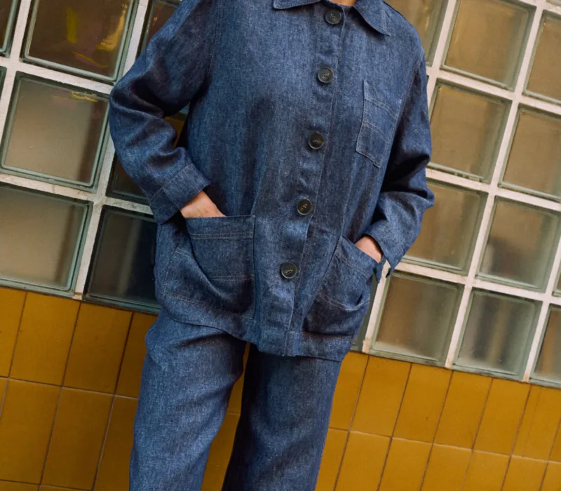 Blue denim linen jeans with wide legs, paired with a matching button-front linen jacket with patch pockets