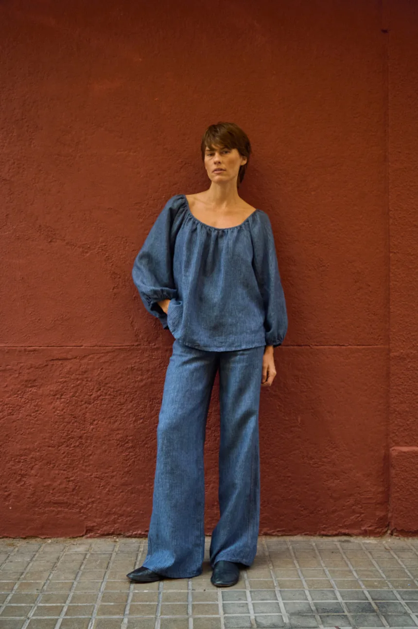 Blue striped linen wide-leg pants styled with a matching relaxed linen blouse