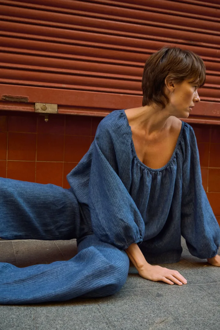 Blue striped linen blouse with a gathered scoop neckline and voluminous sleeves, paired with matching linen pants