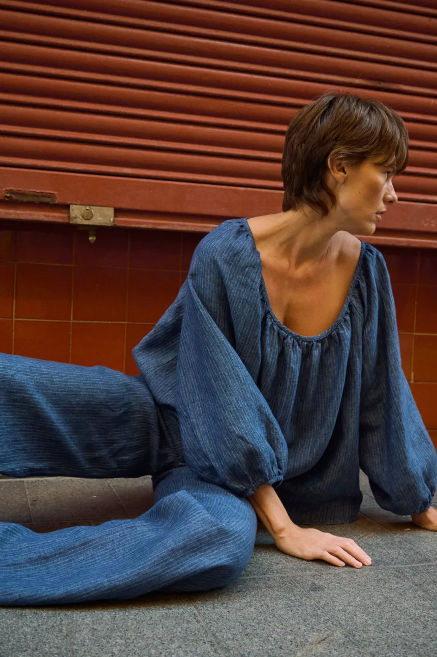 Blue striped linen blouse with a gathered scoop neckline and voluminous sleeves, paired with matching linen pants