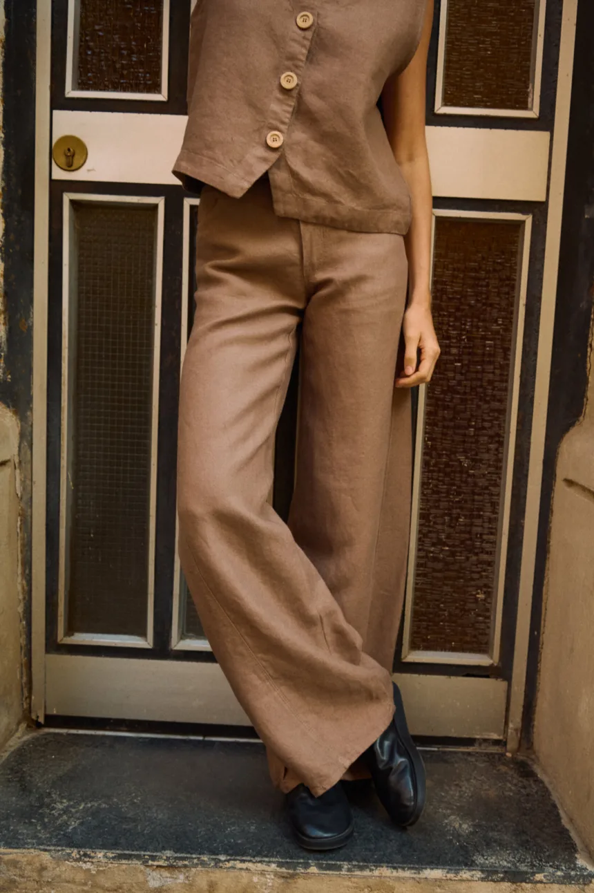 Brown heavy linen wide-leg trousers styled with a matching button-front linen vest
