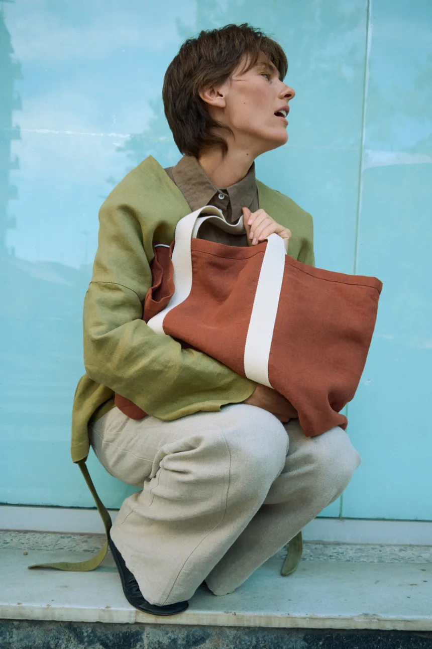 Terracotta heavy linen tote bag with wide cotton webbing handles and roomy structured shape