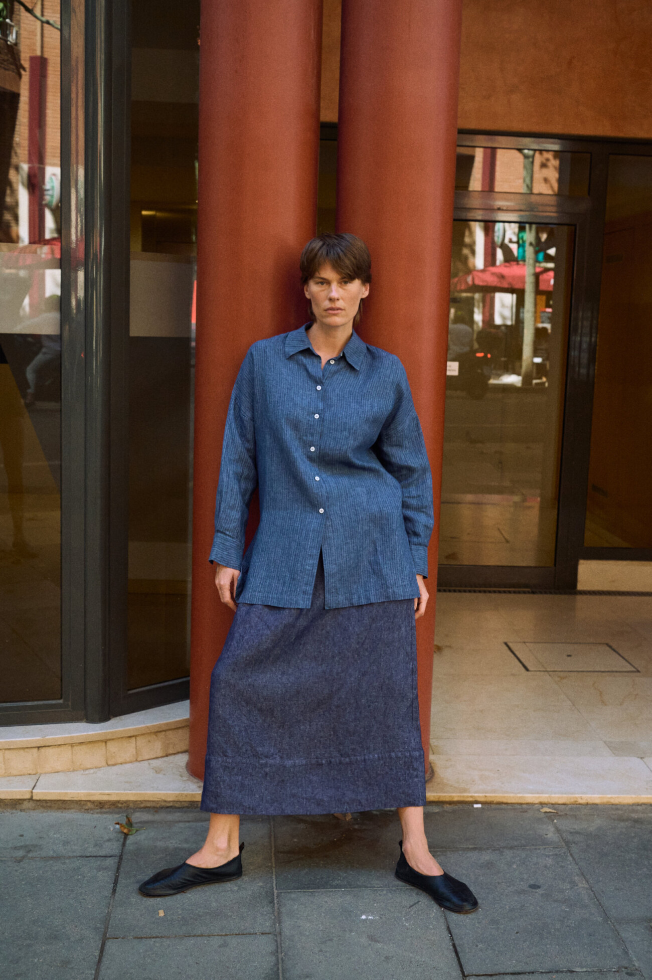 Blue striped linen button-up shirt styled with a long denim linen skirt