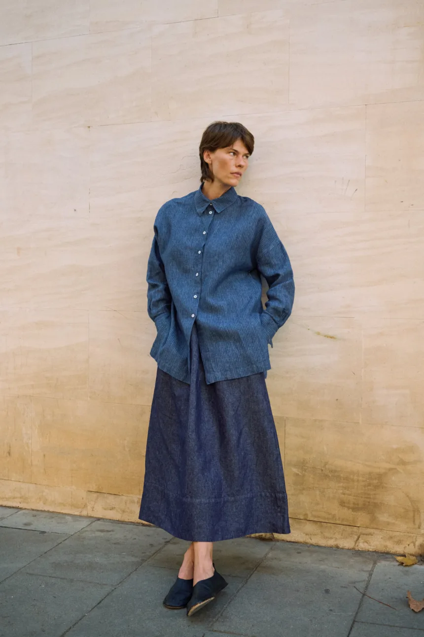 Full-length denim linen maxi skirt with a gently flared shape, paired with an oversized blue striped linen shirt