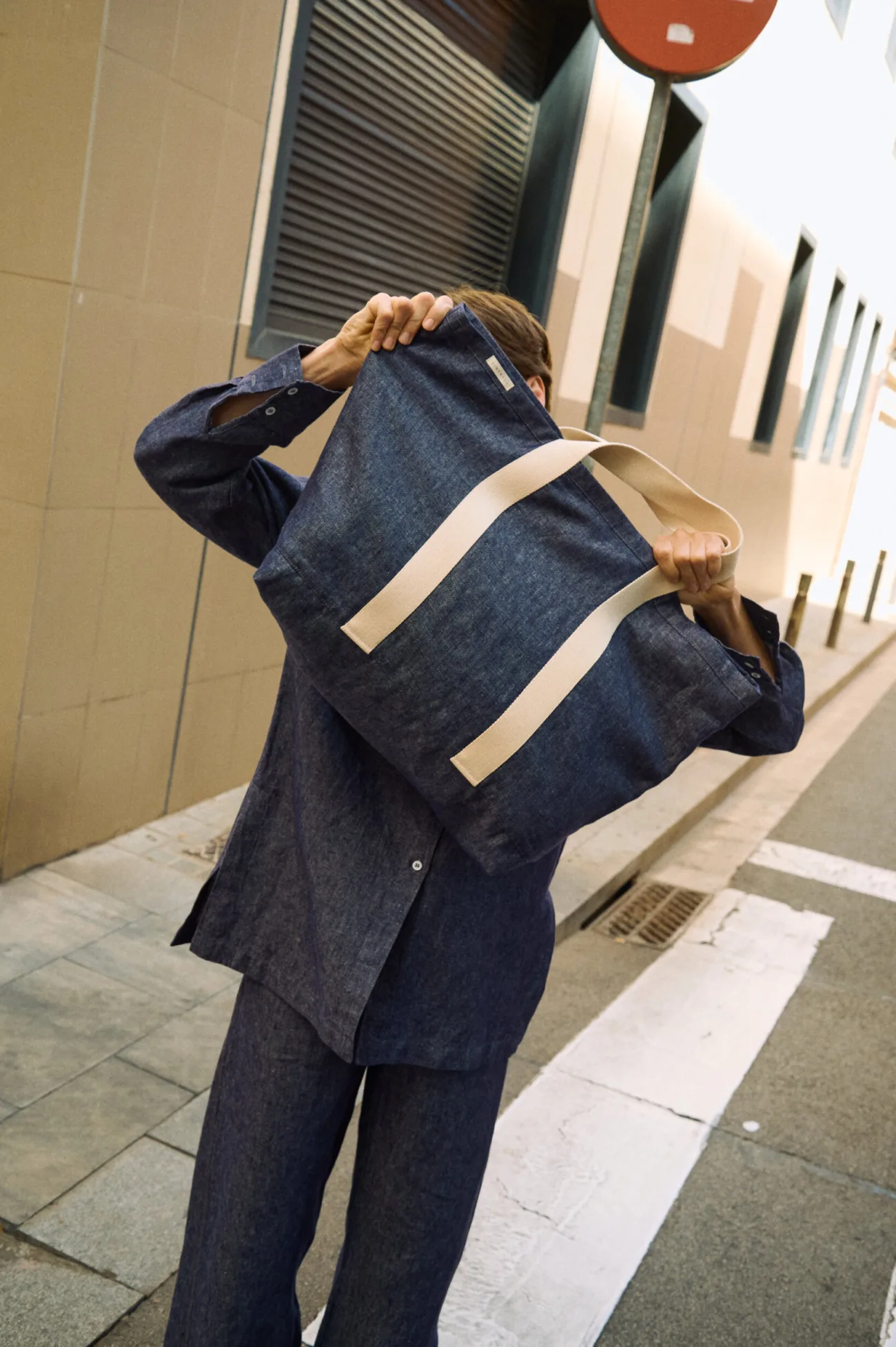Large denim linen tote bag with wide cream cotton handles, styled with a matching denim linen shirt and trousers