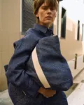 Denim linen tote bag with wide cream cotton handles, shown carried with a matching denim linen shirt