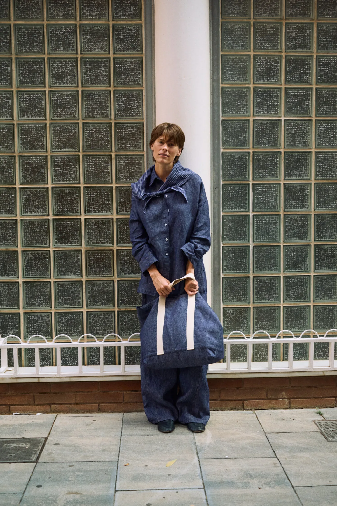 Denim linen large tote bag with wide cream cotton handles, paired with a denim linen shirt, wide-leg trousers and a blue check scarf