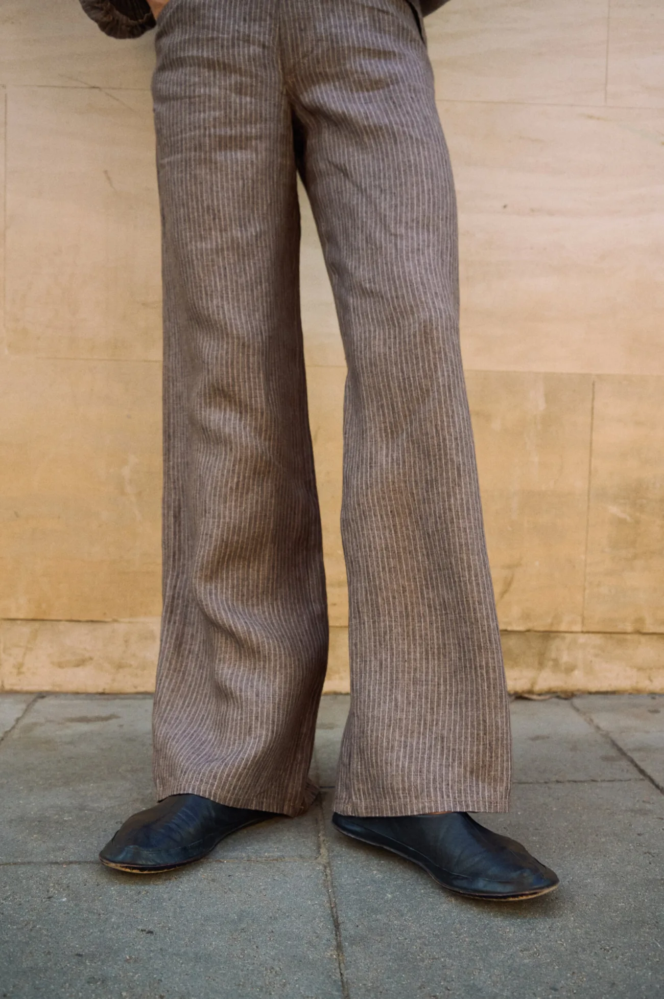 Brown striped linen wide-leg trousers with a relaxed full-length silhouette