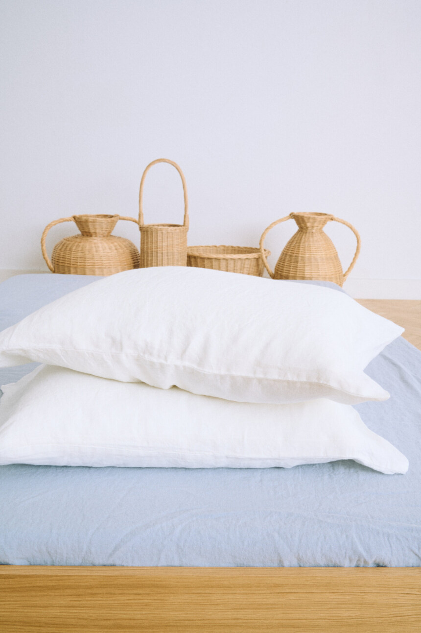 White linen pillowcase in milky white with envelope closure and relaxed washed finish.