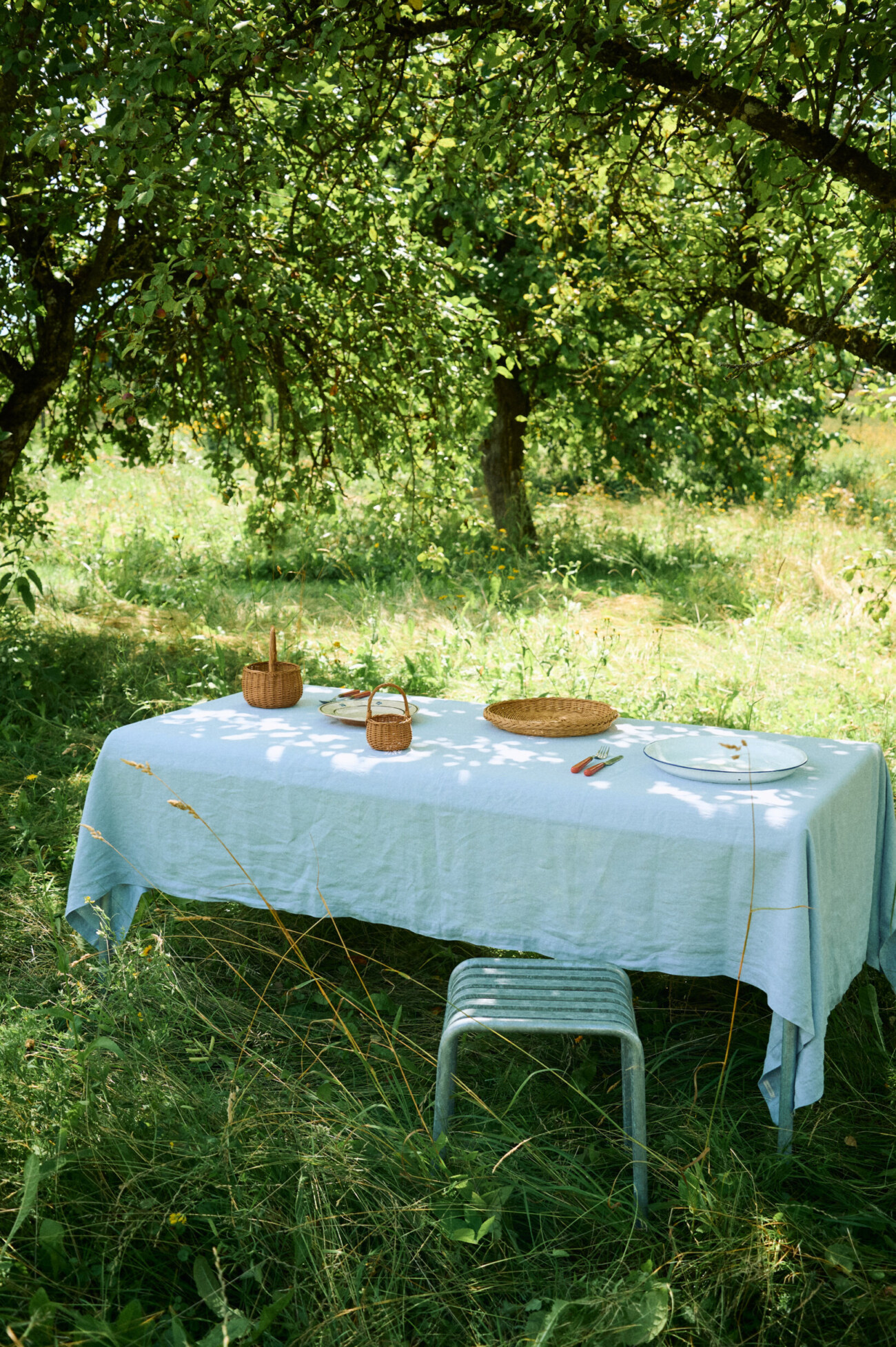 Dusty blue linen tablecloth on a dining table.