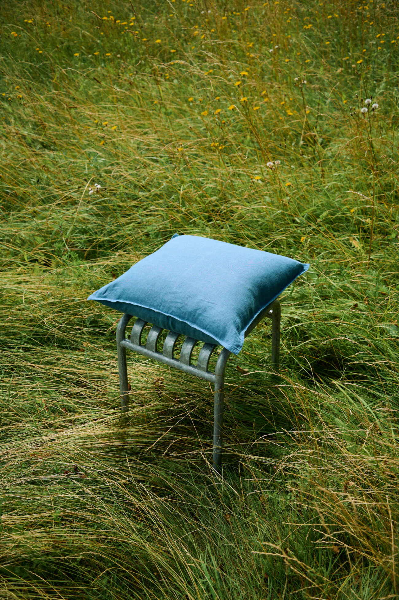 Stellar blue linen pillow cover with decorative stitched edges.